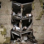 Debris hangs from a residential building heavily damaged in a Russian bombing in Bakhmut, eastern Ukraine, eastern Ukraine, Saturday, May 28, 2022. Fighting has raged around Lysychansk and neighbouring Sievierodonetsk, the last major cities under