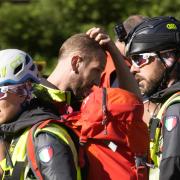 Rescuers prepare to conduct searches for the victims of the Punta Rocca glacier avalanche in Canazei, in the Italian Alps in northern Italy, Tuesday, July 5, 2022, two day after a huge chunk of the glacier broke loose, sending an avalanche of ice, snow,