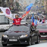 Members of a pro-Kremlin youth organisation ride their cars with flags of Luhansk People Republic along Nevsky prospect, the central avenue of St. Petersburg as they celebrate announced by Russian authorities full control over Luhansk Region, one of the