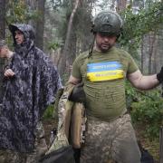 Ukrainian servicemen take their position near the frontline in Kharkiv region, Ukraine, Tuesday, July, 5, 2022. The writing on the T-shirt reads 