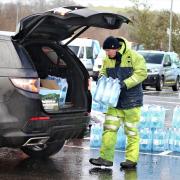 Clarkston residents collect bottled water at a collection point in Williamwood High School in Clarkston after water was cut off over Christmas to thousands of homes in East Renfrewshire