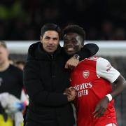 Arsenal manager Mikel Arteta, left, celebrates with Bukayo Saka