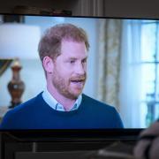 A viewer at home in Edinburgh watching the Duke of Sussex being interviewed by ITV's Tom Bradby during Harry: The Interview, two days before his controversial autobiography Spare is published.