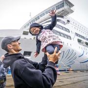 Two-year old Oleksandra Kuleshyna with her father Igor Kuleshyn, from the Freedom Ballet of Ukraine,  alongside MS Victoria in the Port of Leith, Edinburgh.