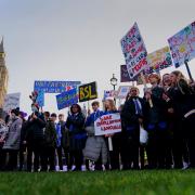 School children take part in a rally in support of British Sign Language becoming a recognised language in the UK, outside the Houses of Parliament