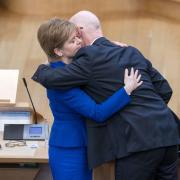 Outgoing First Minister Nicola Sturgeon and outgoing Deputy First Minister John Swinney hug before leaving the main chamber after her last First Minster's Questions (FMQs) in the main chamber of the Scottish Parliament in Edinburg