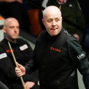 John Higgins cruised into the second round (Mike Egerton/PA)
