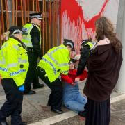 Protestors paint the Scottish Parliament
