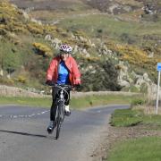 Mavis Paterson cycles uphill
