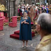 Penny Mordaunt holds the Sword of State at the Coronation ceremony
