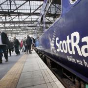 File photograph of passengers exiting a ScotRail train at Glasgow Central station