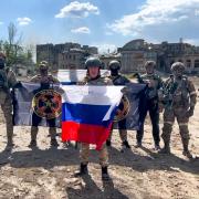 Yevgeny Prigozhin, the head of the Wagner Group military company speaks holding a Russian national flag in front of his soldiers in Bakhmut, Ukraine