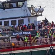 A group of people thought to be migrants are brought in to Dover yesterday. Six people are confirmed to have died when a boat carrying migrants sank off the coast of Sangatte, France, on Saturday.