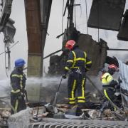 Firefighters tackle a fire after a Russian rocket attack in Kyiv on Wednesday