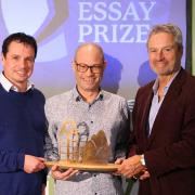 Winner of the 2023 Anne Brown Essay Prize Rodge Glass (centre) is presented with his award by Adrian Turpin (left), Creative Director of the Wigtown Book Festival and broadcaster and author Gavin Esler