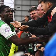 Hibernian forward Elie Youan celebrates with the Easter Road club's fans at Tynecastle today after scoring against Hearts