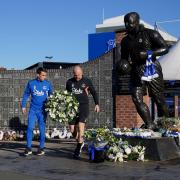 Everton captain Seamus Coleman and manager Sean Dyche lay flowers by the Dixie Dean statue outside Goodison Park in tribute to chairman Bill Kenwright (Peter Byrne/PA)