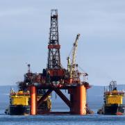 An oil rig being moved through the Cromarty Firth