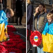 Ukrainian refugees Marichka, 16, and Sviatoslav, nine, lay poppy wreaths for their father Koli in Edinburgh