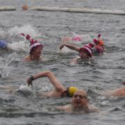 Members of the Serpentine Swimming Club take part in the Peter Pan Cup race, which is held every Christmas Day at the Serpentine, in Hyde Park, central London