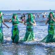 Mermaids take part in the Loony Dook 2024 in Kinghorn, Fife