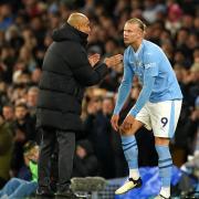 Manchester City manager Pep Guardiola speaks with Erling Haaland (Martin Rickett/PA)