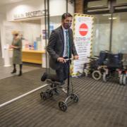 Humza Yousaf riding a scooter in Scottish Parliament