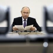 Russian President Vladimir Putin speaks during a meeting as he visits the State Healthcare Institution 