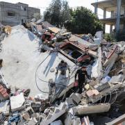 People inspect the damage to their homes following Israeli air strikes on February 20, 2024 in Rafah