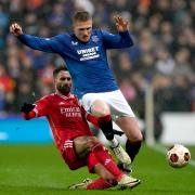 Rangers midfielder John Lundstram is tackled in the Europa League game with Benfica at Ibrox this evening