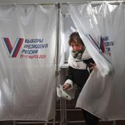 A student of the Maritime State University named after admiral Gennady Nevelskoy casts a ballot at a polling station during the presidential election in the Pacific port city of Vladivostok
