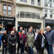 A group of tourists on a Mackintosh-themed walking tour in Glasgow
