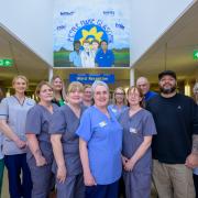 Staff with graffiti artists EJEK at the Marie Curie hospice in Springburn, Glasgow