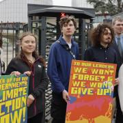 Greta Thunberg joins activists outside the court