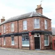 Popular traditional pub with beer garden in historic Scottish town on market