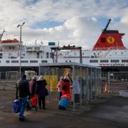 Passengers wait to board the CalMac ferry, Caledonian Isles at Ardrossan bound for Brodick on Arran.