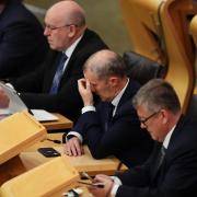 Former health secretary Michael Matheson, pictured centre, has been supspended from Holyrood