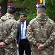 Rishi Sunak speaks with British troops in April (PA)