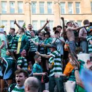 Celtic fans celebrate the Parkhead club's Scottish title win in Glasgow city centre last month
