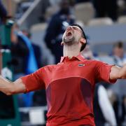 Novak Djokovic celebrates his hard-fought victory (Jean-Francois Badias/AP)