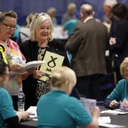 Members of the SNP observe as ballot papers are counted in Perth