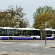 A bus with 'I identify as a trolleybus' on the side