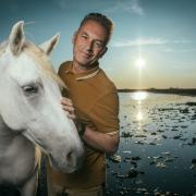 Chris Packham and horses in the Camargue, France. He will visit the area later in the series