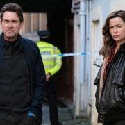 DI Stanley and DCI Kilburn (Dougray Scott, Eve Myles) check out the crime scene.