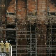 Firefighters survey the damage to the Glasgow School of Art Mackintosh building