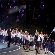 Alex Marshall, flag bearer of Scotland alongside Sarah Adlington, baton bearer leads the delegation during the opening ceremony for the 2026 Commonwealth Games in Glasgow