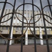 People walk in front of the Russian Olympic Committee building in Moscow