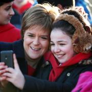 First Minister Nicola Sturgeon has a selfie taken with children from Tolcross Primary School at Edinburgh Castle esplanade as  Visit Scotland launches its new VisitScotland campaign. PRESS ASSOCIATION Photo. Picture date: Wednesday February 10, 2016.