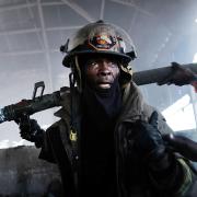 Firefighters work to put out a blaze at Port-au-Prince's historic Iron Market on February 13, 2018 in Port-au-Prince, Haiti
