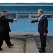 North Korean Leader Kim Jong Un (L) and South Korean President Moon Jae-in (R) shake hands over the military demarcation line upon meeting for the Inter-Korean Summit on April 27, 2018 in Panmunjom, South Korea.  GETTY